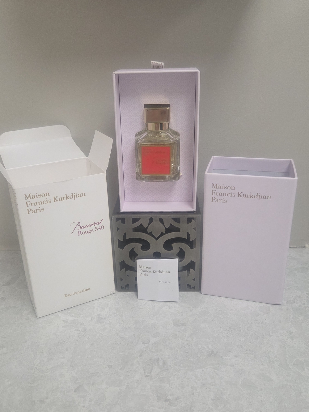 Maison Francis Kurkdjian perfume with pale pink packaging and red label